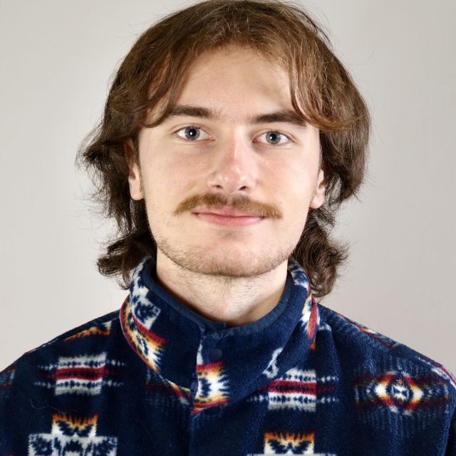 Image of Michigan State University student Zachary Christiansen in a patterned shirt against an off-white background.