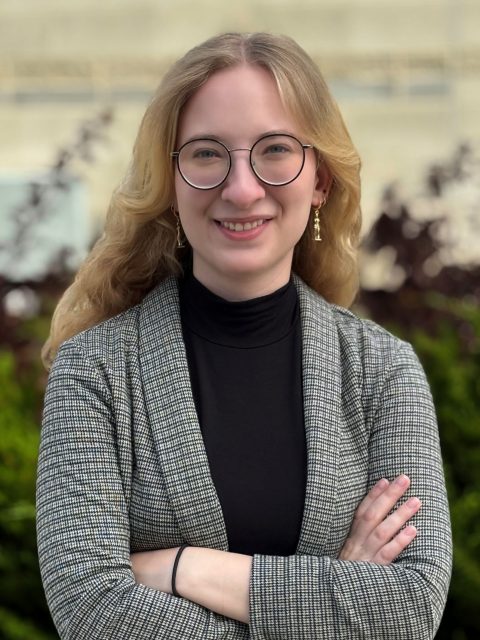 Image of Michigan State University student Kierra Jursch smiling in a grey blazer and black top, with arms crossed.