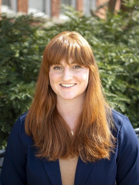 Image of Michigan State University student Isabelle Radakovich in a navy blazer, with greenery in the background.