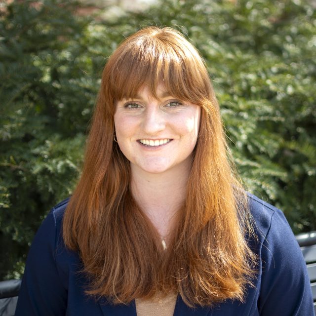 Image of Michigan State University student Isabelle Radakovich in a navy blazer, with greenery in the background.