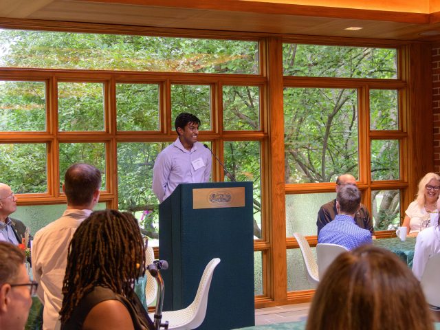 Aaron Philip speaks at the podium for an Honors College scholarship recipient and donor dinner on MSU’s campus in Cowles House.