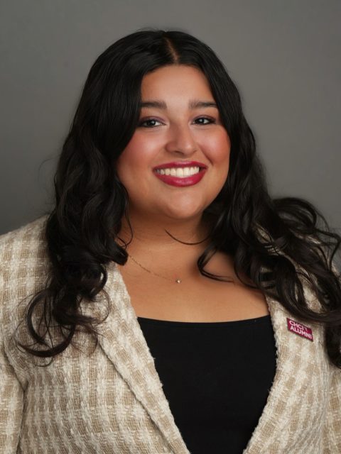 Michigan State University student and Voyager Scholarship recipient Anabelle Sanchez smiling in a plaid white and tan blazer, wearing a red CHCI ALUMNI pin.