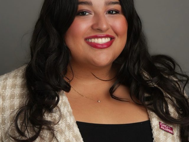 Michigan State University student and Voyager Scholarship recipient Anabelle Sanchez smiling in a plaid white and tan blazer, wearing a red CHCI ALUMNI pin.
