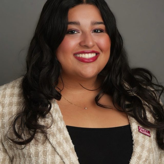 Michigan State University student and Voyager Scholarship recipient Anabelle Sanchez smiling in a plaid white and tan blazer, wearing a red CHCI ALUMNI pin.