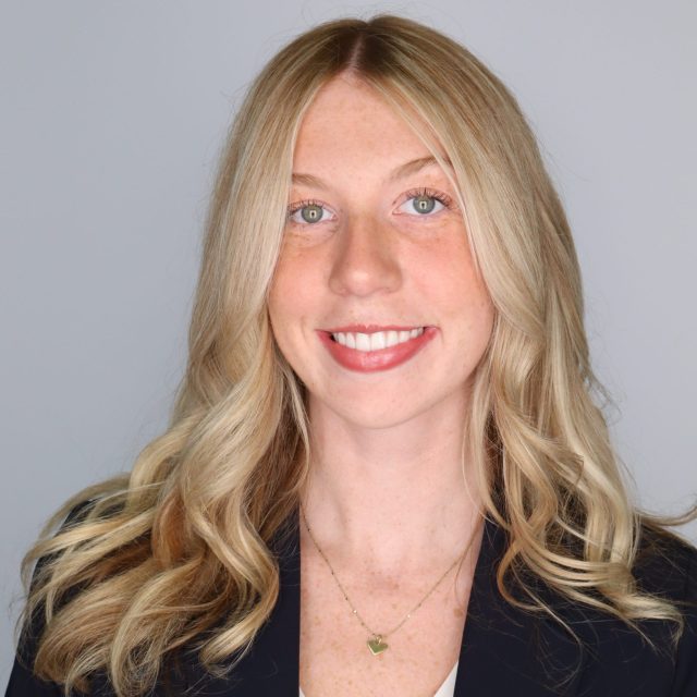 MSU student and Rhodes Scholarship nominee Ashlin Stover smiling against a neutral grey background in a white top and black blazer.